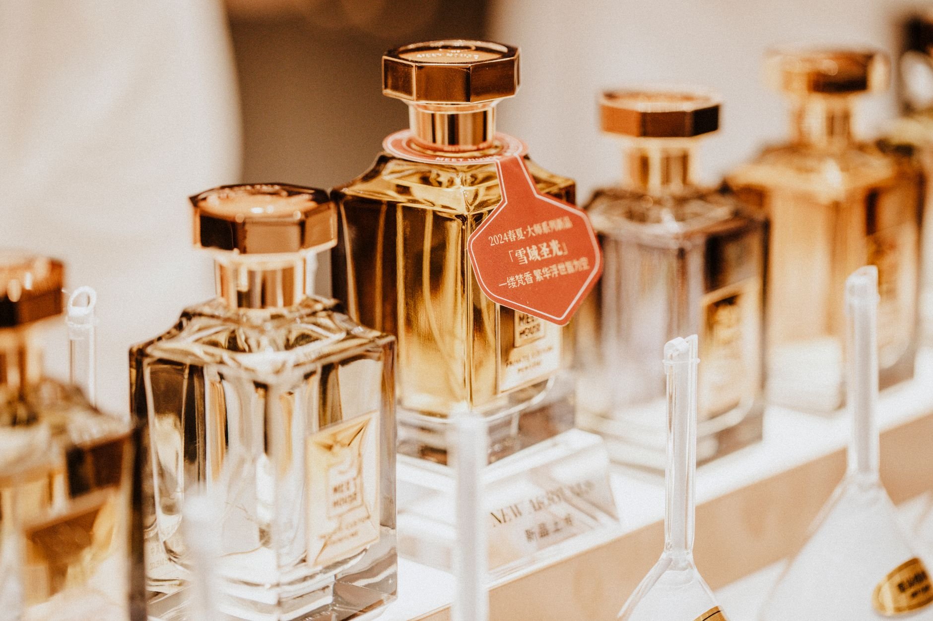 Elegant collection of perfume bottles showcasing luxury fragrances in a stylish retail display.